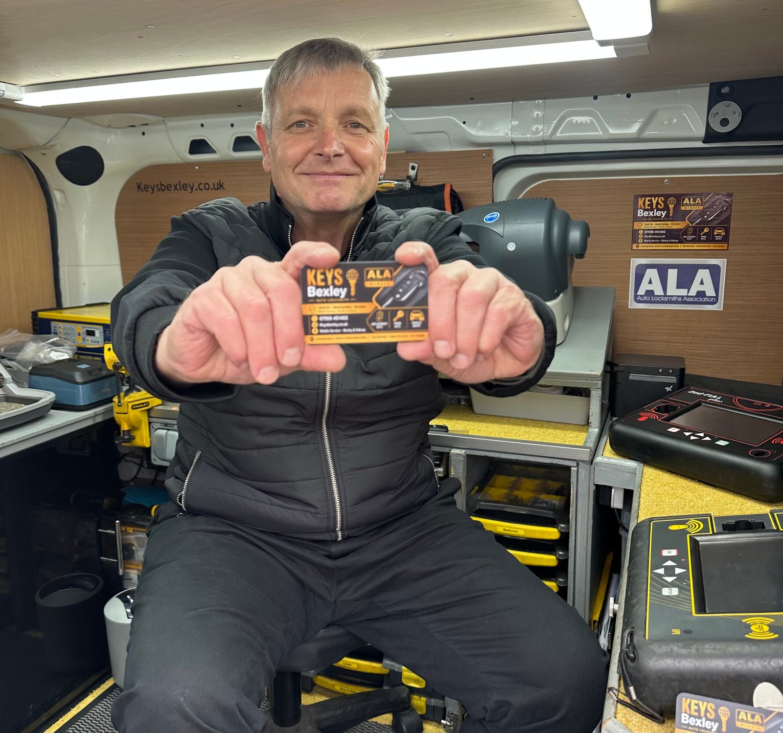 Terry from Keys Bexley inside his mobile auto locksmith workshop