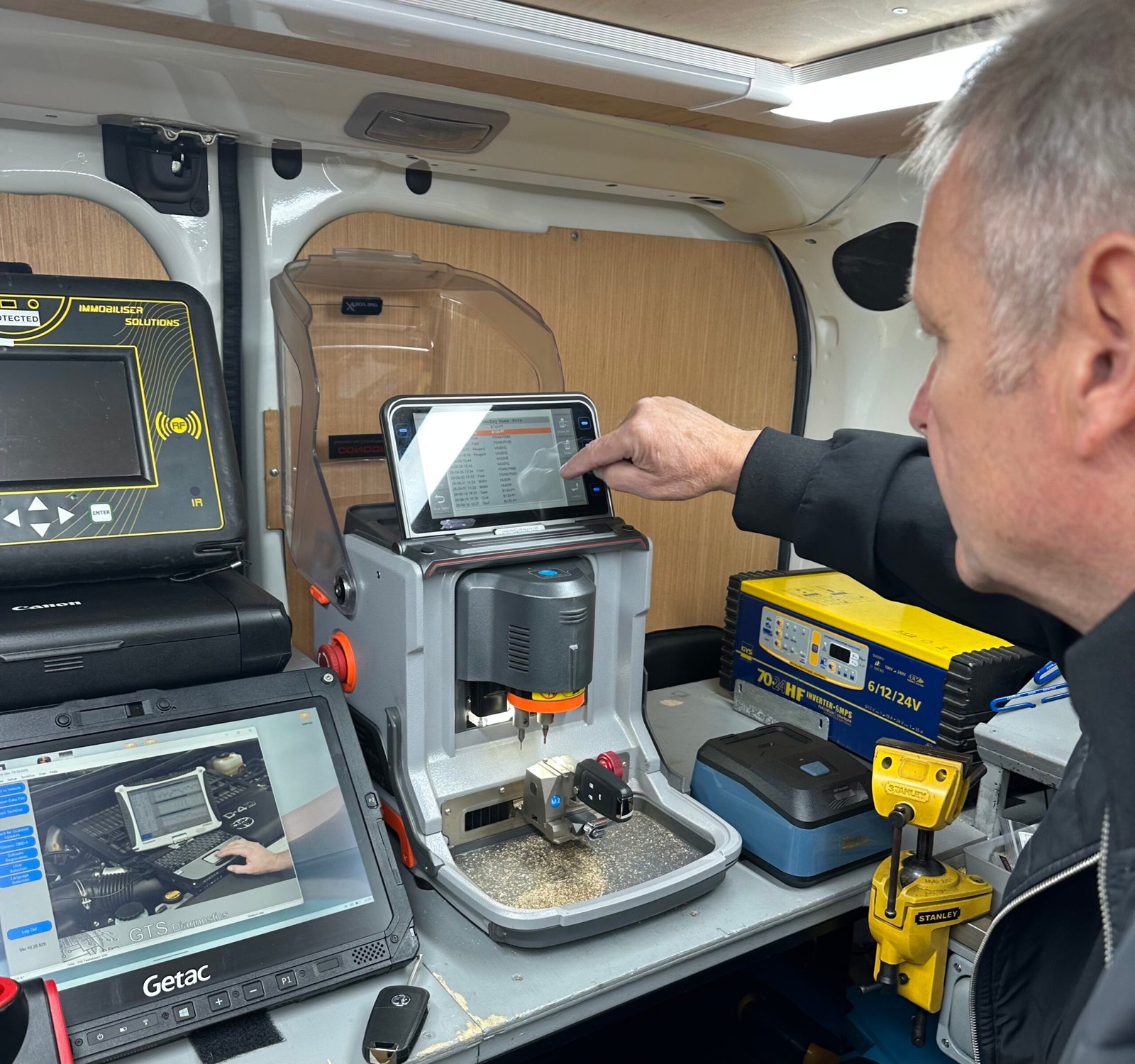 Terry using specialist car key cutting equipment in the Keys Bexley mobile workshop